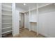 Walk-in closet with white shelving, ample storage space, and a mirror at 7801 N 4Th Pl, Phoenix, AZ 85020