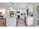 Bright kitchen with white cabinets, stainless steel appliances, and a large island with pendant lighting at 7801 N 4Th Pl, Phoenix, AZ 85020