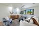 Bright living room with a ceiling fan, stylish furniture, and a large window view of the front yard at 7801 N 4Th Pl, Phoenix, AZ 85020