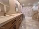 Stylish bathroom featuring a double vanity with marble countertops and backsplash with a separate area for the toilet at 7955 E Chaparral Rd # 34, Scottsdale, AZ 85250