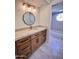 Bathroom features a light wood vanity with marble countertops, an oval mirror, and decorative lighting fixtures at 7955 E Chaparral Rd # 34, Scottsdale, AZ 85250