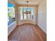 A light-filled dining area features a large bay window, hardwood floors, and a modern chandelier at 7955 E Chaparral Rd # 34, Scottsdale, AZ 85250