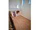 Light-filled living room, featuring a pass-through window to the kitchen, light-colored wood floors, and high ceilings at 7955 E Chaparral Rd # 34, Scottsdale, AZ 85250