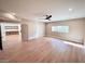 Spacious main bedroom featuring hardwood floors, a ceiling fan, a large window and custom closet systems at 7955 E Chaparral Rd # 34, Scottsdale, AZ 85250