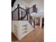 Beautiful staircase with dark wood railings, white risers, and built-in shelving creates an attractive focal point at 7955 E Chaparral Rd # 34, Scottsdale, AZ 85250