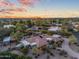 Beautiful aerial view showcasing a desert home with pool, lush greenery, and circular driveway at 8724 N 68Th St, Paradise Valley, AZ 85253