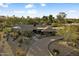 Wide aerial view of home, circular driveway, and lush, mature desert landscaping at 8724 N 68Th St, Paradise Valley, AZ 85253