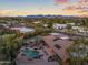 This aerial view of a desert home features a pool and landscape, emphasizing the property's beauty and location at 8724 N 68Th St, Paradise Valley, AZ 85253