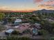 An aerial view of a desert home with a pool and lush desert landscaping, showcasing the property's beauty at 8724 N 68Th St, Paradise Valley, AZ 85253