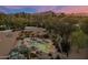 Aerial view of home, pool, and patio area surrounded by mature desert landscaping at 8724 N 68Th St, Paradise Valley, AZ 85253