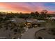 Panoramic aerial view of property with lush desert landscaping at sunset at 8724 N 68Th St, Paradise Valley, AZ 85253