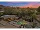 Breathtaking aerial view of backyard oasis, desert landscape, and mountain range in the distance at 8724 N 68Th St, Paradise Valley, AZ 85253