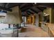 Covered back patio with a fireplace, outdoor kitchen, and comfortable seating area at 8724 N 68Th St, Paradise Valley, AZ 85253