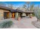 Covered back patio with an outdoor fireplace and comfortable seating for relaxation and outdoor entertaining at 8724 N 68Th St, Paradise Valley, AZ 85253