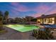 Backyard featuring a pool, lounge chairs, lush greenery, and desert landscape at twilight at 8724 N 68Th St, Paradise Valley, AZ 85253