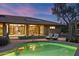 Backyard with pool, desert landscaping, lounge chairs, and seamless indoor-outdoor transition at 8724 N 68Th St, Paradise Valley, AZ 85253