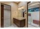 Bathroom with granite countertop vanity, makeup mirror, and step-in glass shower at 8724 N 68Th St, Paradise Valley, AZ 85253