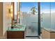 Beautiful glass countertop bathroom vanity with stone tile and an outdoor shower at 8724 N 68Th St, Paradise Valley, AZ 85253