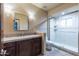 Bathroom featuring a walk-in shower, vanity with a large mirror, and a tiled countertop at 8724 N 68Th St, Paradise Valley, AZ 85253