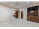Spacious bedroom featuring neutral colors, carpet, and built-in media center with shelves and drawers at 8724 N 68Th St, Paradise Valley, AZ 85253