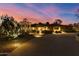 Stunning desert landscaping surrounds this home with a circular drive and lighted walkway at 8724 N 68Th St, Paradise Valley, AZ 85253