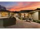 Inviting home exterior featuring warm sunset colors, front patio seating, and unique architectural details at 8724 N 68Th St, Paradise Valley, AZ 85253