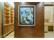 Hallway with unique art and built-in shelving leading to a bathroom space at 8724 N 68Th St, Paradise Valley, AZ 85253