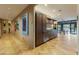 Hallway view showcasing artwork and leading to a modern kitchen and bright outdoor space at 8724 N 68Th St, Paradise Valley, AZ 85253