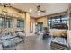 Bright home gym featuring mirrored wall, rubber flooring, and a variety of fitness equipment for a complete workout at 8724 N 68Th St, Paradise Valley, AZ 85253