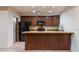 Well-appointed kitchen with dark wood cabinets, granite countertops, and modern appliances, perfect for cooking at 8724 N 68Th St, Paradise Valley, AZ 85253