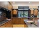Elegant kitchen with dark wood cabinetry, marble countertops, and stainless steel appliances at 8724 N 68Th St, Paradise Valley, AZ 85253