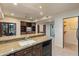 Stylish kitchenette featuring granite countertops, dark cabinets, and open access to additional living areas at 8724 N 68Th St, Paradise Valley, AZ 85253
