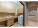 Laundry room with front-load washer, dryer, and built-in cabinets at 8724 N 68Th St, Paradise Valley, AZ 85253