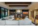 Warm living room featuring a fireplace, built-in shelving, beamed ceilings, and comfortable furnishings at 8724 N 68Th St, Paradise Valley, AZ 85253