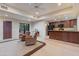 Cozy living room with stone floors, leather chairs, and adjacent kitchen area, blending comfort and functionality at 8724 N 68Th St, Paradise Valley, AZ 85253