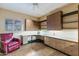 Bright home office with built-in desk, cabinets, and a comfortable chair at 8724 N 68Th St, Paradise Valley, AZ 85253