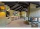 An outdoor patio featuring a built-in grill, countertop, and a stone fireplace with comfortable seating at 8724 N 68Th St, Paradise Valley, AZ 85253