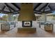 Charming outdoor patio showcasing a stone fireplace, comfortable seating, and desert landscaping at 8724 N 68Th St, Paradise Valley, AZ 85253