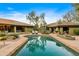 Beautiful pool area with lounge chairs, lush desert landscaping, and a serene backyard view at 8724 N 68Th St, Paradise Valley, AZ 85253