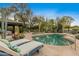 Backyard pool featuring desert landscaping, comfortable lounge chairs, and views of the home's unique architecture at 8724 N 68Th St, Paradise Valley, AZ 85253