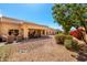 Beautiful backyard features a covered patio, outdoor furniture, mature trees and desert landscaping at 8850 W Piute Ave, Peoria, AZ 85382