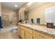 Stylish bathroom features ample storage, tiled shower, granite counters, and neutral colors at 8850 W Piute Ave, Peoria, AZ 85382