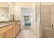 Bathroom leads into the main bedroom with clear shower, natural light, and granite counters at 8850 W Piute Ave, Peoria, AZ 85382