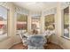 Bright breakfast nook featuring a large window, comfortable seating, and vinyl floors at 8850 W Piute Ave, Peoria, AZ 85382