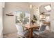 Bright dining area with a wooden table and lots of natural light from the window at 8850 W Piute Ave, Peoria, AZ 85382
