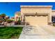 Tan home exterior featuring a well-manicured front lawn and a two-car garage at 8850 W Piute Ave, Peoria, AZ 85382