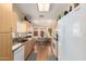 Bright eat-in kitchen with a large window, wood floors, granite counters, and modern appliances at 8850 W Piute Ave, Peoria, AZ 85382