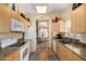 Bright eat-in kitchen featuring wood floors, granite counters, and modern appliances at 8850 W Piute Ave, Peoria, AZ 85382
