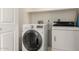 Modern laundry room with white appliances and ample space for laundry needs at 8850 W Piute Ave, Peoria, AZ 85382
