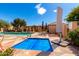 Community pool and jacuzzi area with lounging chairs, umbrellas and desert landscaping at 8850 W Piute Ave, Peoria, AZ 85382
